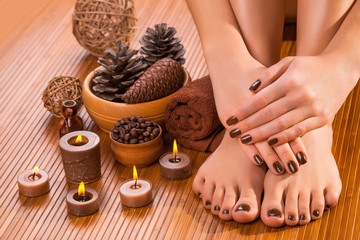 brown manicure and pedicure on the bamboo