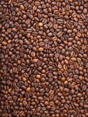 Numerous coffee beans which have been scattered all over the sur