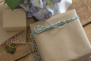 gift box wrapped in recycled paper with green ribbon bow