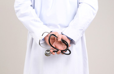 Male Doctor standing  on gray background