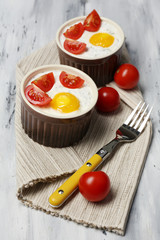 Baked eggs on wooden table close up