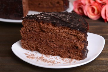 Delicious chocolate cake on table close-up