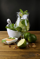 Ingredients for lemonade on wooden table, on grey background