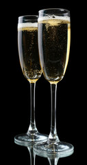 Glasses of champagne, on black background