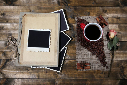 Composition with coffee cup and photo album,