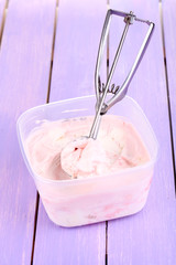 Ice cream in container and ice cream spoon