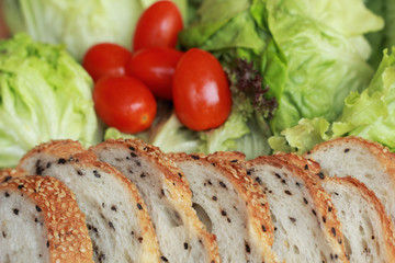 bread sprinkled with sesame -  vegetable green salad