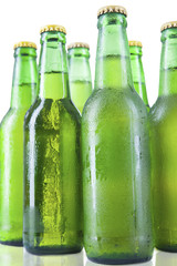 Bottles of beer with drops isolated