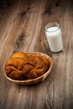 Bread and a glass of milk on the wooden table