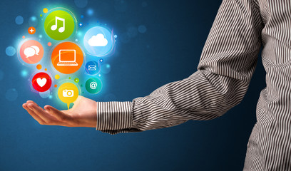 Multimedia icons in the hand of a businessman