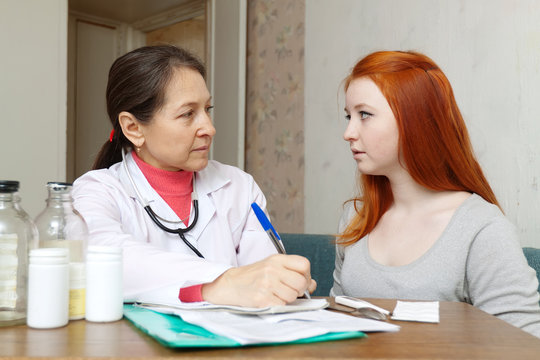 mature doctor examining teenage girl