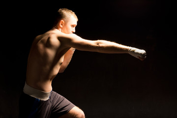 Boxer making a jabbing punch during a boxing match