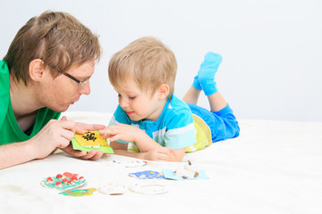 father and son looking at baby crafts