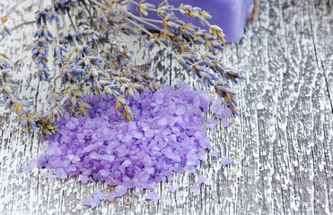 Bath salt for aromatherapy and dried lavender on an old wood tab