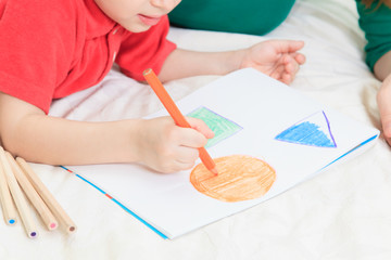 child drawing shapes