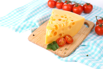 Piece of cheese and tomatoes, on wooden board, isolated on