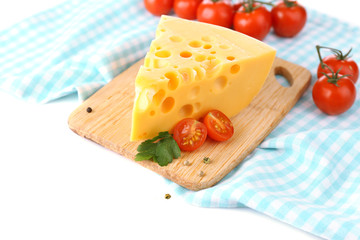Piece of cheese and tomatoes, on wooden board, isolated on