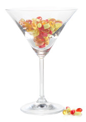 Goblet with pills isolated on white