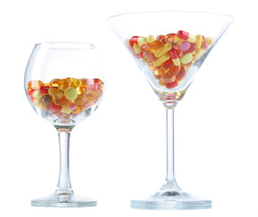 Goblets with pills isolated on white