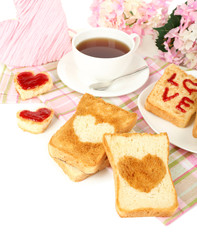 Delicious toast with jam and cup of tea on table close-up