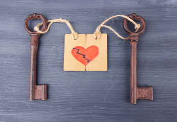 Keys to heart, Conceptual photo. On color wooden background