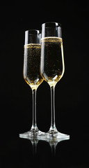 Glasses of champagne, on black background