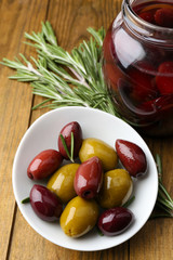 Tasty olives on wooden table