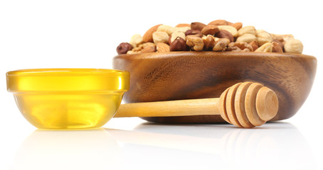 Sweet honey and different nuts, isolated on white