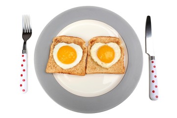 Scrambled eggs with bread on plate, on color napkin