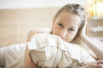 Naklejka premium portrait of a beautiful young woman in her bedroom