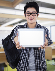 Young man showing digital tablet