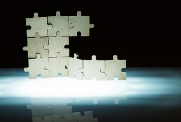 Fototapeta premium Wooden puzzle and backlight background. Close up