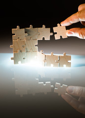 Wooden puzzle and backlight background. Close up
