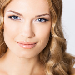 Obraz premium Young cheerful smiling woman, on gray