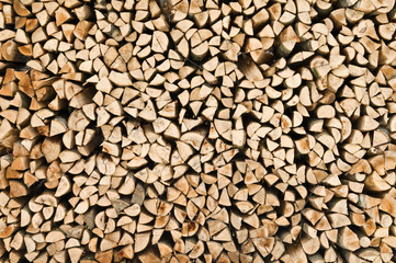 many raw firewood logs stacked texture background