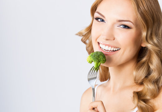 Woman Eating Broccoli, Over Gray