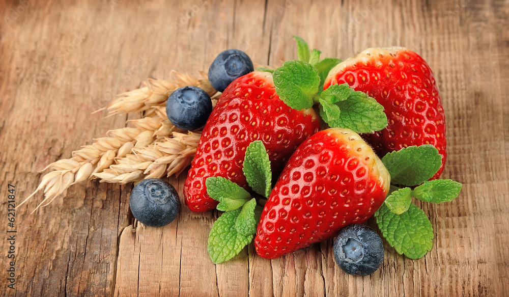 Wall mural Strawberry and blueberries with mint.