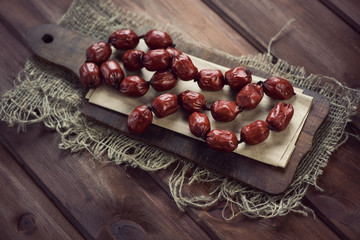 Rustic wooden chopping board with smoked mini sausages
