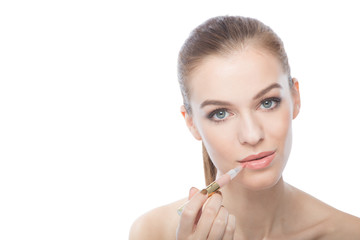 Woman applying lipstick, isolated on a white background