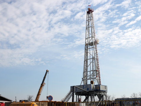 oil drilling rig and crane on field