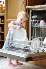 toddler girl helping in the kitchen with dish washing machine