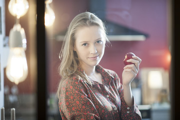 portrait of a beautiful young woman holding an apple in his hand