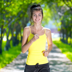 Runner - woman running outdoors in green park