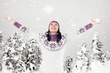 Beautiful ,young woman with arms outstretched , winter season