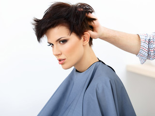Fototapeta premium Brown Hair. The Hairdresser doing Hairstyle in Hair Salon. 