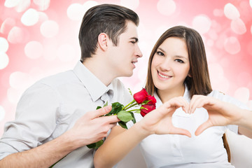 Man giving red rose to a woman, she make hearth by hands