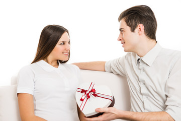 Man giving heart shape gift box to a woman.White background