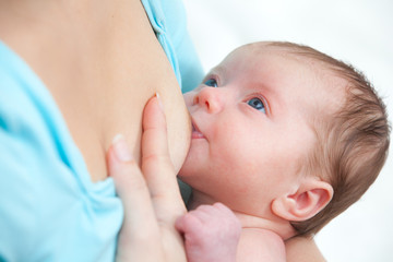 Obraz na płótnie Canvas Mother breast feeding newborn baby
