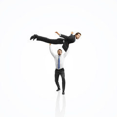 one businessman lifting the second one and helping him to fly
