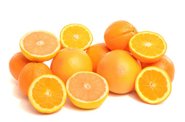 Pile of fresh organic oranges and grapefruits isolated on white.